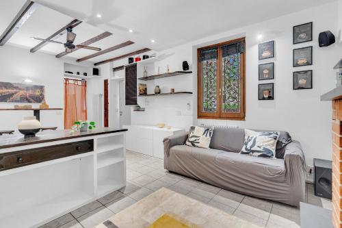 a living room with a couch and a kitchen at Ripa 11 Comfort Flat in Milan