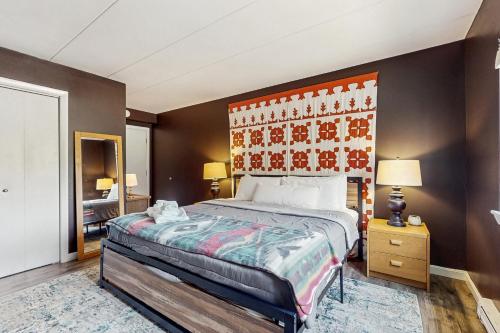 a bedroom with a large bed with an orange headboard at 5B Mountain Village- Unit B in Dover