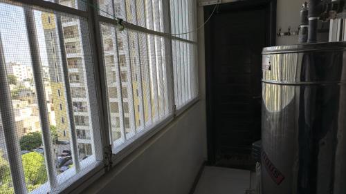 a room with a window with a view of a building at Home Sweet Home in Karachi