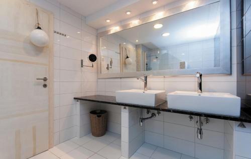 a bathroom with two sinks and a mirror at Villa Pucalo by Villas Guide in Kampor