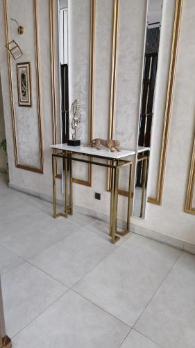 a table with a cat sitting on top of it at Home Sweet Home in Karachi