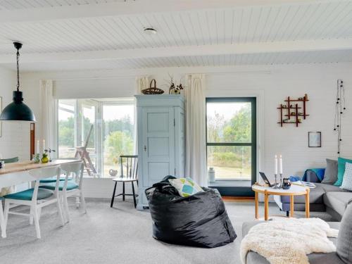 a living room with a couch and a table at Holiday Home Thersten - 500m to the fjord by Interhome in Løgsted