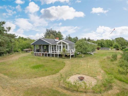 a house in the middle of a grassy field at Holiday Home Thersten - 500m to the fjord by Interhome in Løgsted