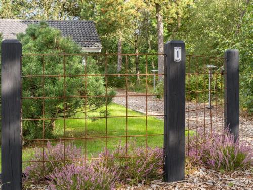a gate in a garden with purple flowers at Holiday Home Grimi - 4km from the sea by Interhome in Fjerritslev