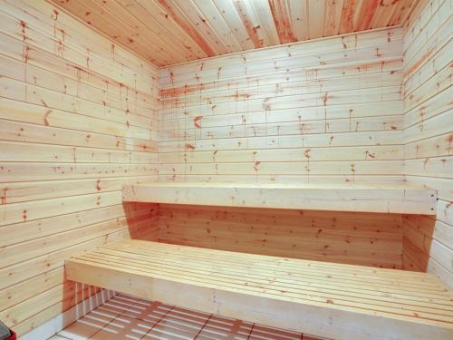 a wooden sauna with a bench in it at Holiday Home Magh by Interhome in Års
