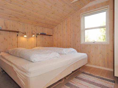 a bedroom with a bed in a room with a window at Holiday Home Einette - 3-5km from the sea by Interhome in Fjerritslev