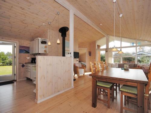 a kitchen and dining room with a table in a house at Holiday Home Einette - 3-5km from the sea by Interhome in Fjerritslev