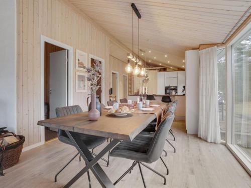 a dining room with a long table and chairs at Holiday Home Sighbiorn - 950m from the sea by Interhome in Fjerritslev