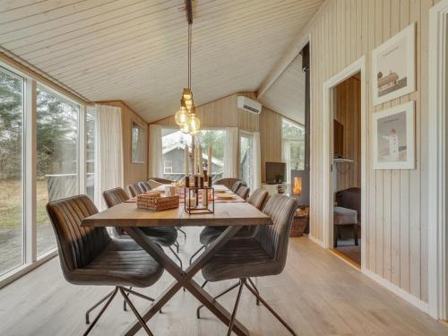 a dining room with a table and chairs at Holiday Home Sighbiorn - 950m from the sea by Interhome in Fjerritslev