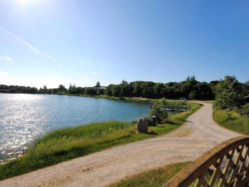a dirt road next to a body of water at Holiday Home Alvira - 8km to the fjord by Interhome in Fjerritslev
