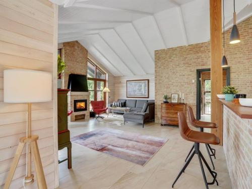 a living room with a couch and a fireplace at Holiday Home Andri - 600m to the fjord by Interhome in Løgstør