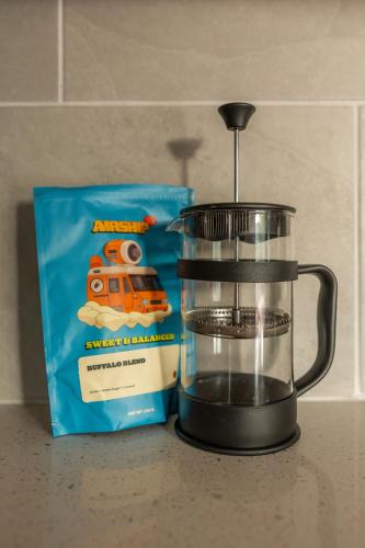 a food processor sitting next to a box of oatmeal at Downtown Bentonville The Cozy Switchback Entire Home with Biking and Trails Steps Away Including Hot Tub and Firepit in Bentonville