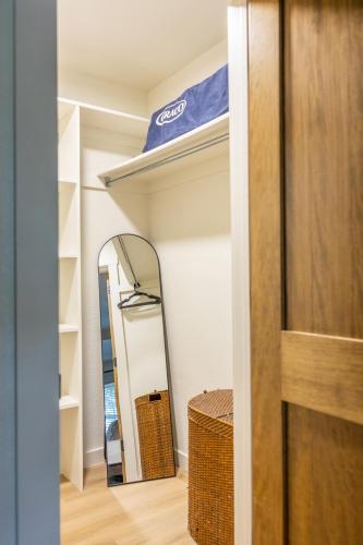a room with a mirror and a shelf at Downtown Bentonville The Cozy Switchback Entire Home with Biking and Trails Steps Away Including Hot Tub and Firepit in Bentonville