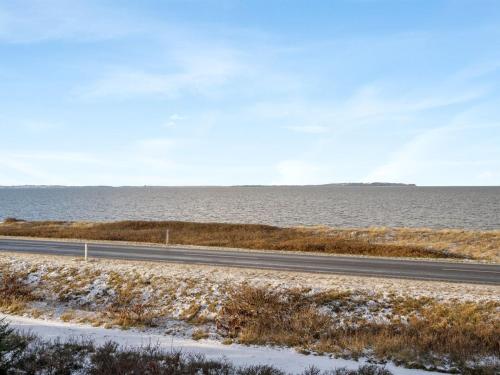 a road next to a body of water at Holiday Home Freda - 100m to the inlet by Interhome in Løgsted