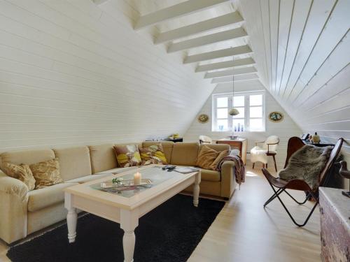 a living room with a couch and a table at Holiday Home Tamer - 500m to the fjord by Interhome in Farsø