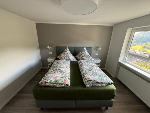 a bed in a room with two pillows on it at Ferienwohnung Waldrose in Oberharmersbach