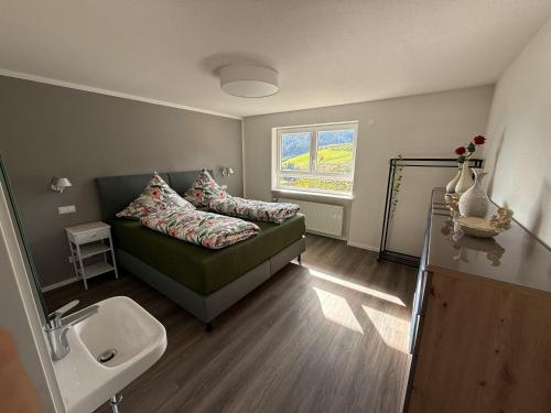 a living room with a couch and a sink at Ferienwohnung Waldrose in Oberharmersbach