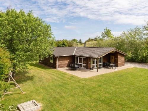 a log cabin with a patio and a yard at Holiday Home Els - 900m from the sea by Interhome in Fjerritslev