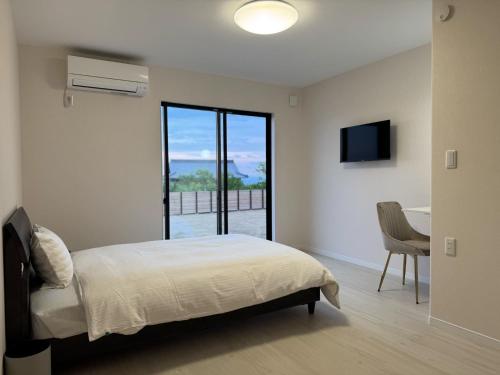 a bedroom with a bed and a desk and a window at Awaji - House - Vacation STAY 19734 in Awaji