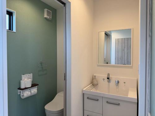 a bathroom with a sink and a toilet and a mirror at Awaji - House - Vacation STAY 19734 in Awaji