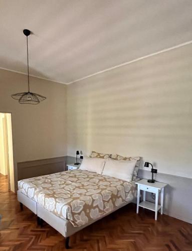 a bedroom with a bed and two night tables at Casa Amrita B&B in Teramo