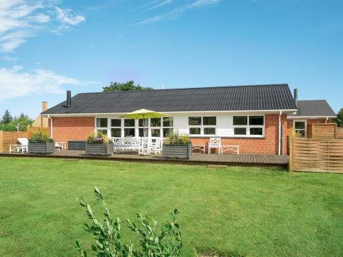a house with a lawn in front of it at Holiday Home Swipdagh - 600m from the sea by Interhome in Fjerritslev