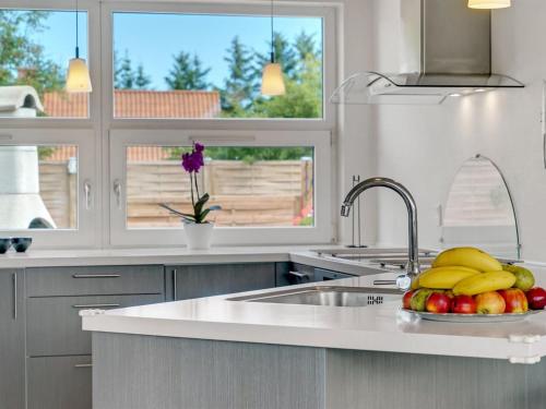 a kitchen with a sink and a bowl of fruit at Holiday Home Swipdagh - 600m from the sea by Interhome in Fjerritslev