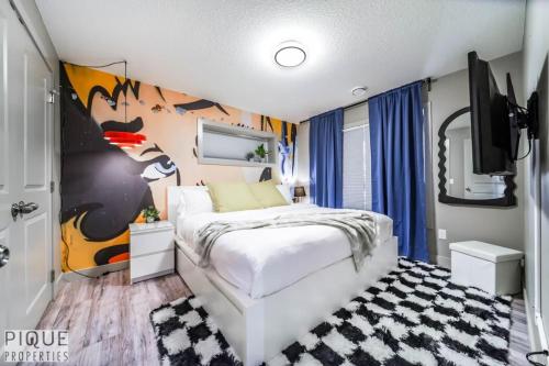 a bedroom with a bed and a wall with a cow mural at Chic 6BDRM Getaway - KingBed - Patio - BBQ - Garage - Wifi in Edmonton