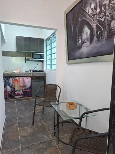 a dining room with a glass table and chairs at Akoya Meraki Casa Hotel in El Silencio