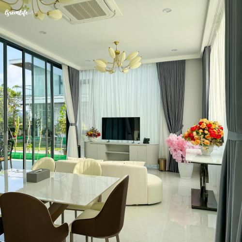 a living room with a white couch and a table at Greenlife Village Phú Quốc in Phu Quoc
