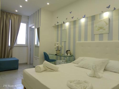 a bedroom with a white bed and a blue chair at Maison De luxe in Pompei
