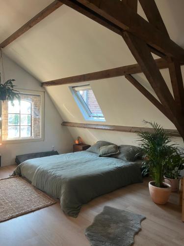 a bedroom with a large bed in a attic at RetreatHouse in Lith