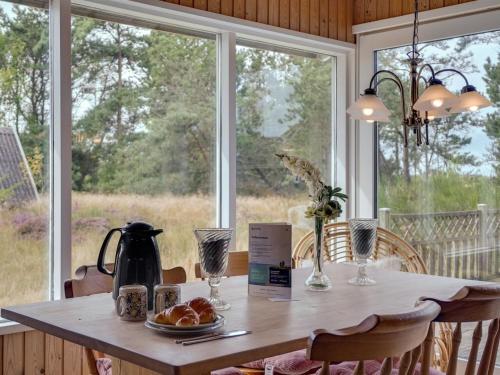a table in a room with a large window at Holiday Home Asmara - 200m from the sea by Interhome in Læsø