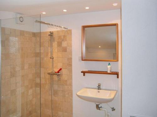 a bathroom with a sink and a shower with a mirror at Holiday Home Siggi - 400m from the sea by Interhome in Jerup