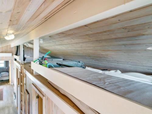 a room with a wooden ceiling and a counter top at Holiday Home Bothilda - 660m from the sea by Interhome in Bindslev