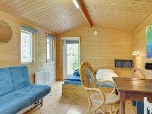 a room with a bed and a couch and a table at Holiday Home Ascen - 300m from the sea by Interhome in Læsø
