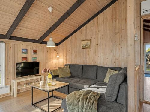a living room with a couch and a tv at Holiday Home Eliana - 350m from the sea by Interhome in Strandby