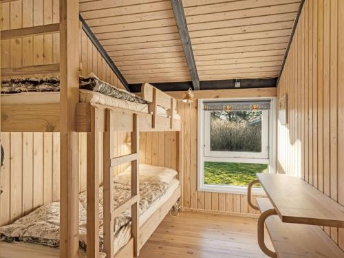 a room with bunk beds and a window at Holiday Home Eliana - 350m from the sea by Interhome in Strandby