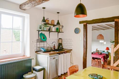 a kitchen with a sink and a table at Maison de charme, quartier thermal in Bourbon-Lancy