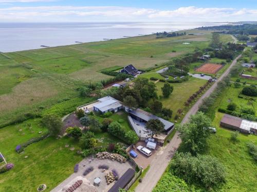 an aerial view of a house in a field at Holiday Home Marlena - 150m from the sea by Interhome in Frederikshavn