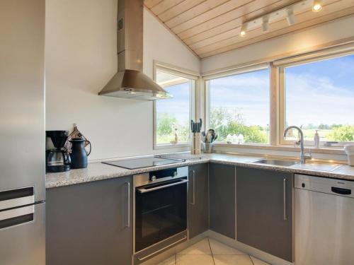 a kitchen with stainless steel appliances and a window at Holiday Home Hampus - 500m from the sea by Interhome in Strandby