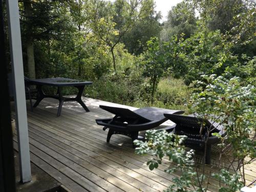 a wooden deck with a table and chairs on it at Holiday Home Laurine - 2-7km from the sea by Interhome in Jerup