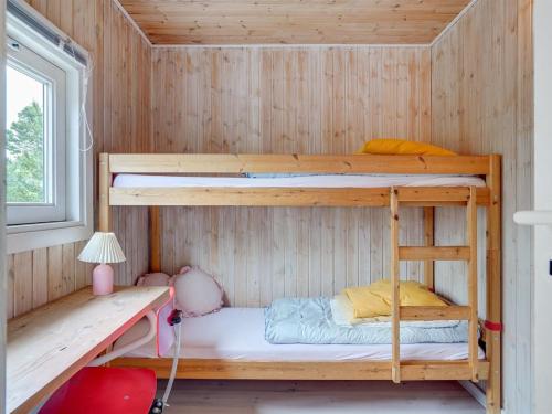a bunk bed room with two bunk beds in a cabin at Holiday Home Arun - 150m from the sea by Interhome in Læsø