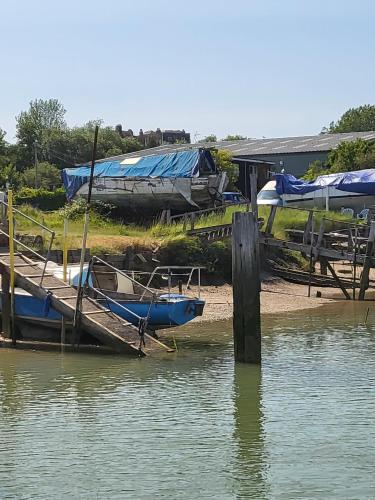 two boats are docked at a dock in the water at Rūm by the beach in Camber