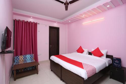 a bedroom with a bed and a television in it at Hotel O Golden Palace in Ghaziabad