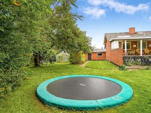 an empty trampoline in the yard of a house at Holiday Home Mats - 5-3km from the sea by Interhome in Løkken
