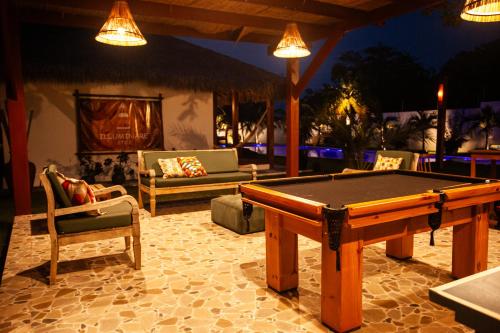 a pool table and chairs in a patio at night at Hotel de Charme Illuminare Stile in Fortim