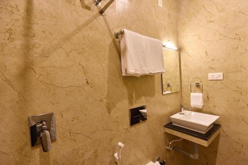 a bathroom with a sink and a mirror at ASJ Holiday Villa in Puducherry