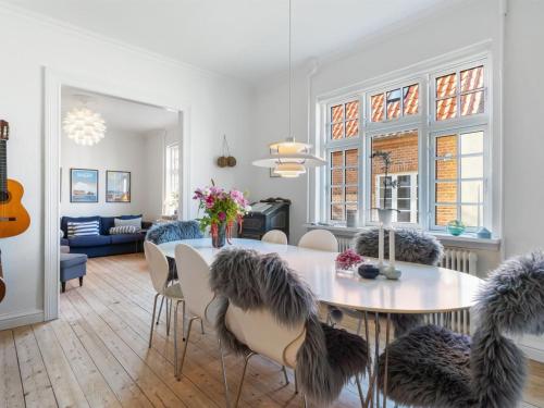a dining room and living room with a table and chairs at Holiday Home Ortrud - 200m from the sea by Interhome in Skagen