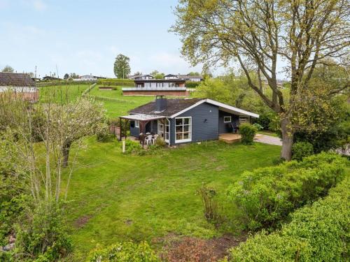 a house in the middle of a yard at Holiday Home Venla - 150m from the sea by Interhome in Augustenborg